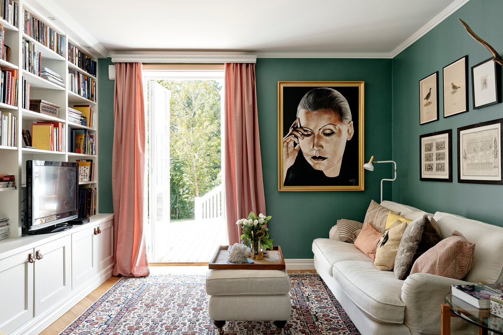 Design ideas for a medium sized scandi formal enclosed living room in Stockholm with green walls, light hardwood flooring, no fireplace and a freestanding tv.