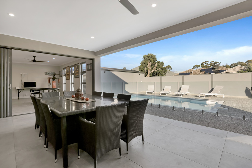 Photo of a large contemporary back veranda in Adelaide with an outdoor kitchen, tiled flooring and a roof extension.