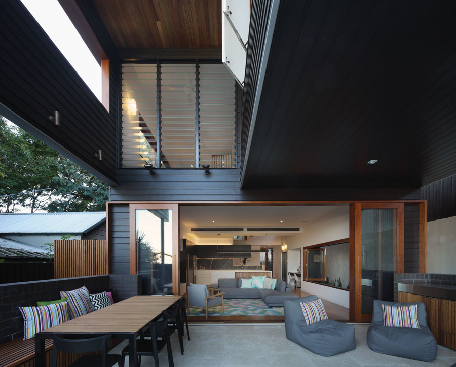 Inspiration for a contemporary concrete paver back porch remodel in Brisbane