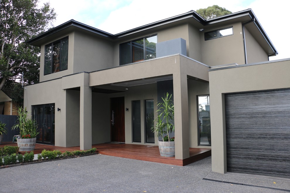 Medium sized modern front veranda in Melbourne with decking and a roof extension.