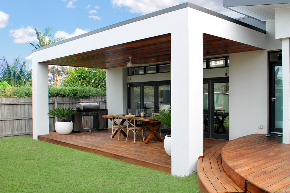Mid-sized minimalist back porch idea in Melbourne with decking