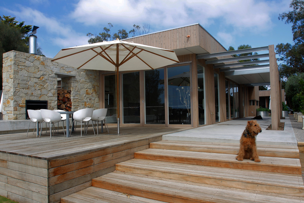 This is an example of a medium sized modern back veranda in Melbourne with a fire feature.