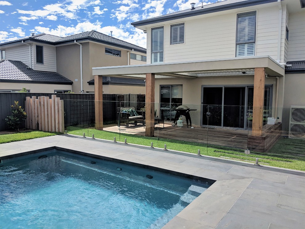Design ideas for a large modern back veranda in Melbourne with decking and a roof extension.