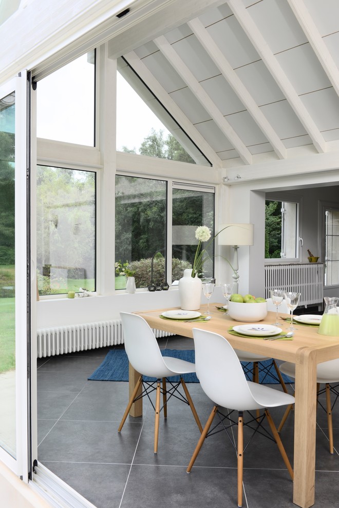 Medium sized contemporary conservatory in Lyon with ceramic flooring, no fireplace, a standard ceiling and grey floors.