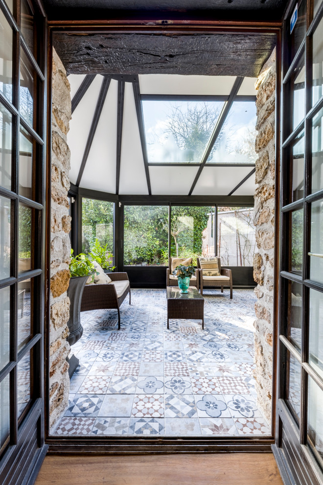This is an example of a medium sized rural conservatory in Paris with a skylight.