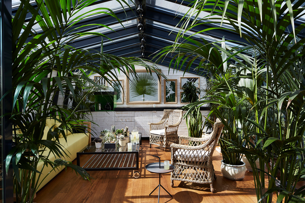 Foto de galería contemporánea de tamaño medio con suelo de madera en tonos medios y techo con claraboya