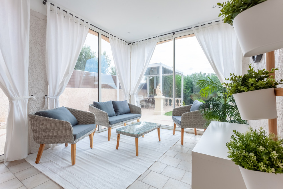 Photo of a traditional conservatory in Paris with a skylight and beige floors.