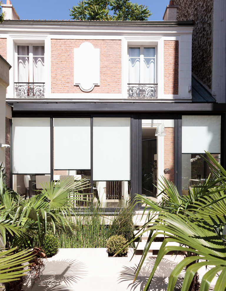 This is an example of a medium sized traditional conservatory in Paris.