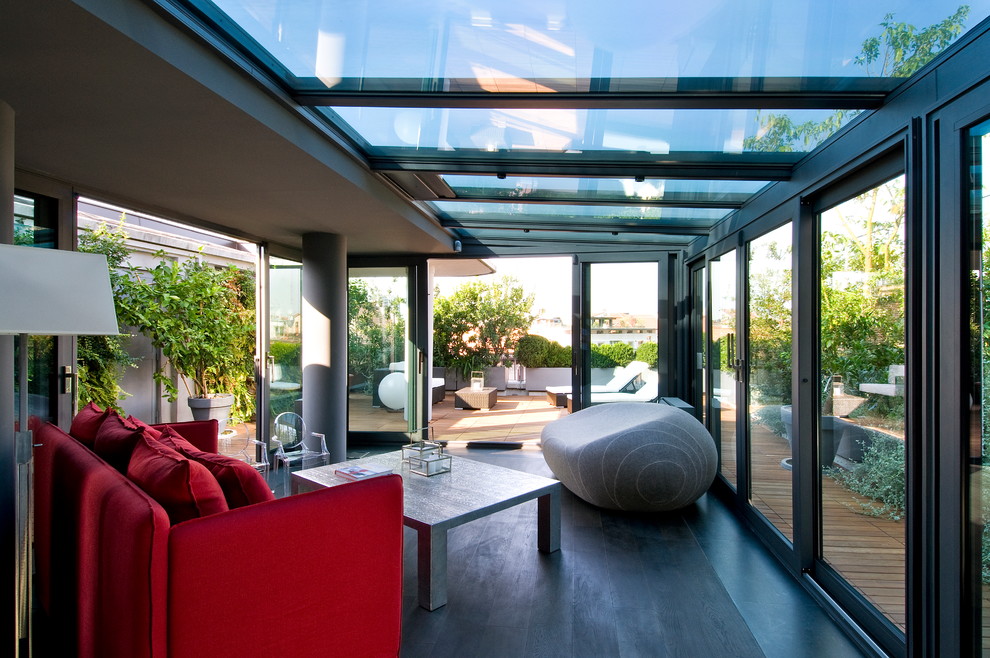 Inspiration for a contemporary conservatory in Milan with dark hardwood flooring and a glass ceiling.