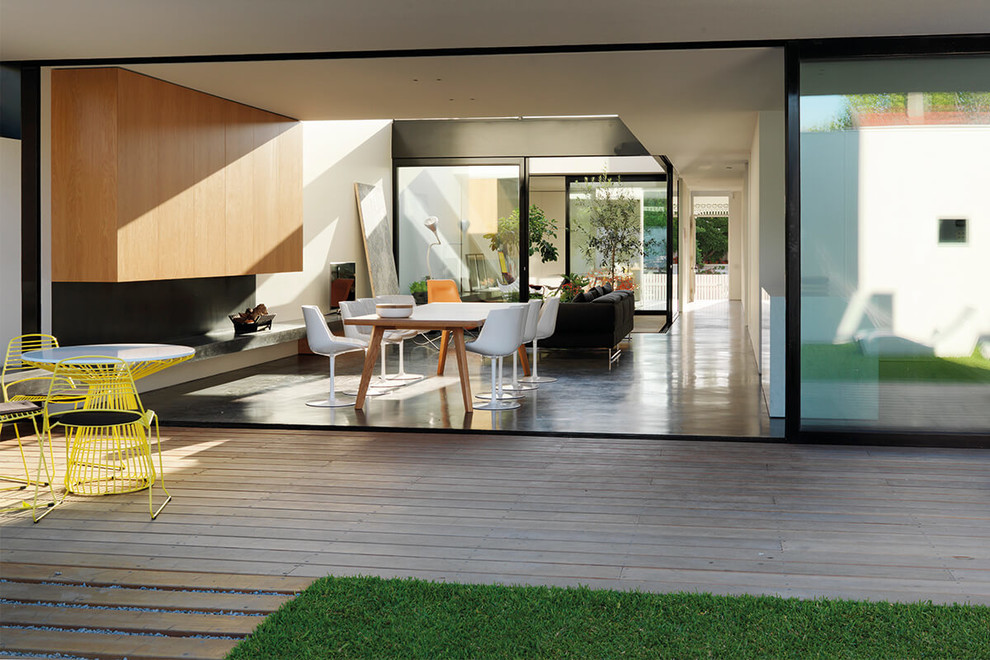 Expansive modern conservatory in Milan with medium hardwood flooring.
