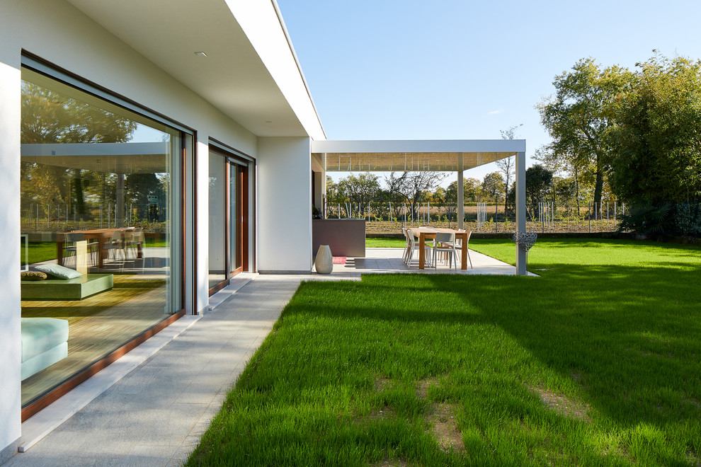Esempio di una veranda minimal di medie dimensioni con pavimento in pietra calcarea e pavimento grigio