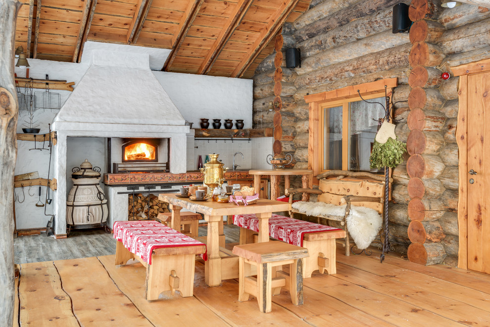 Inspiration for a rustic outdoor kitchen porch remodel in Moscow with a roof extension and decking
