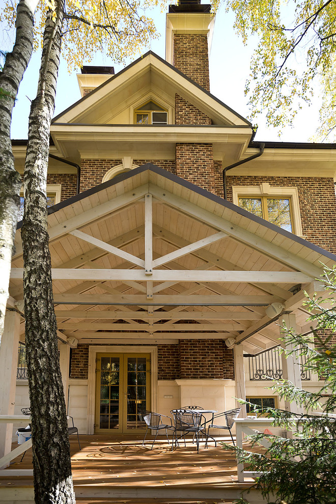 Inspiration för en mellanstor vintage veranda på baksidan av huset, med takförlängning och marksten i betong
