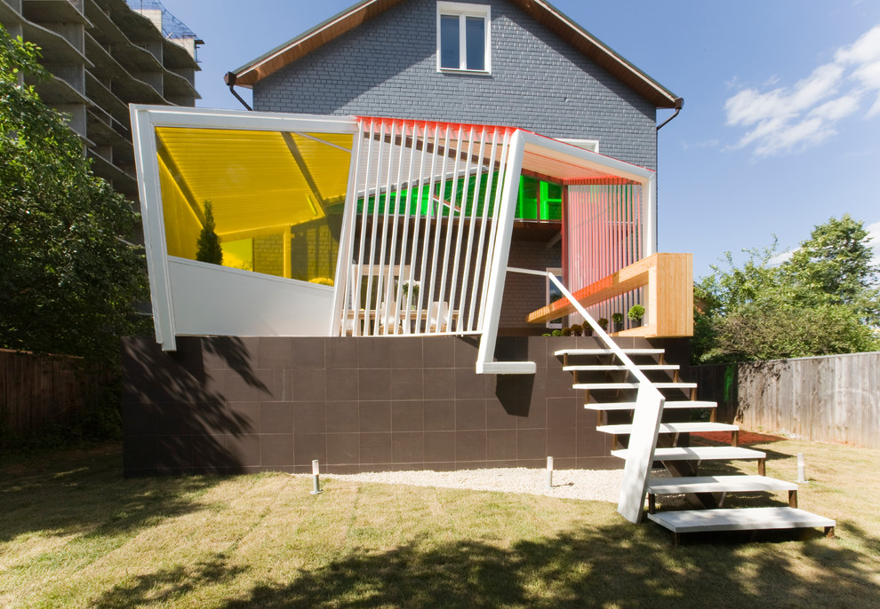 Photo of a small contemporary back veranda in Moscow with a roof extension.