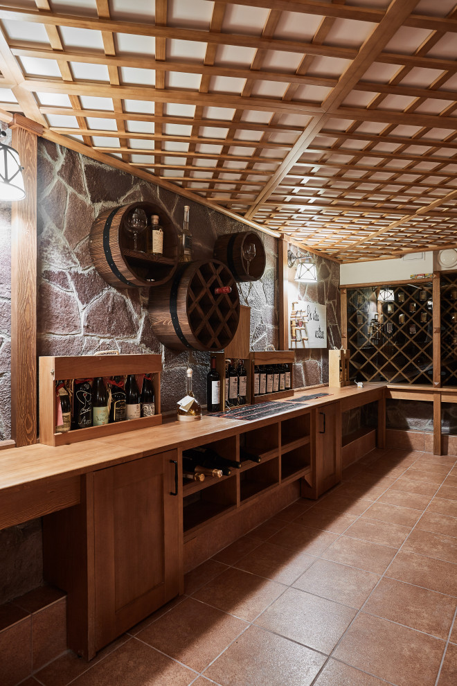 Large classic wine cellar in Yekaterinburg with ceramic flooring and storage racks.