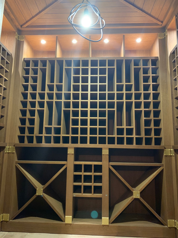 Example of a small classic painted wood floor wine cellar design in Moscow with storage racks