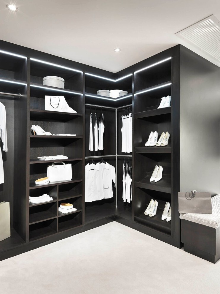 This is an example of an expansive contemporary walk-in wardrobe in Hampshire.