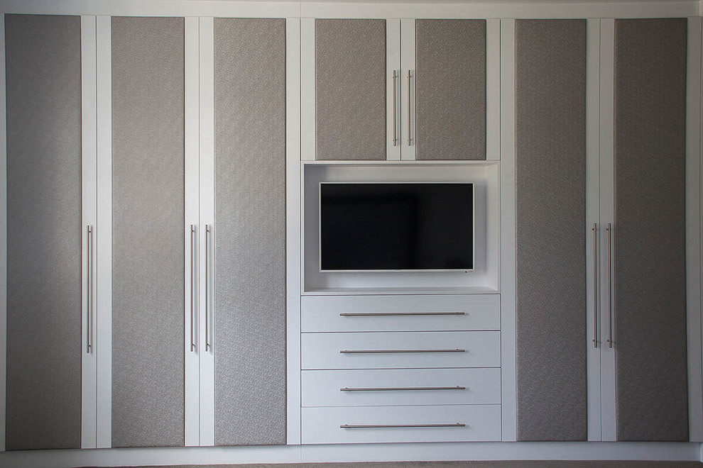 Inspiration for a large contemporary dressing room in London with raised-panel cabinets and grey cabinets.