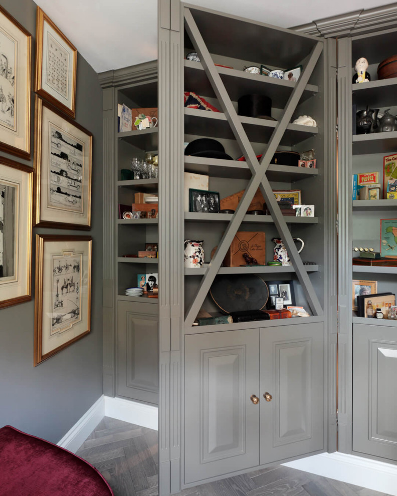 Mid-sized elegant gender-neutral plywood floor, gray floor and coffered ceiling reach-in closet photo in London with open cabinets and green cabinets
