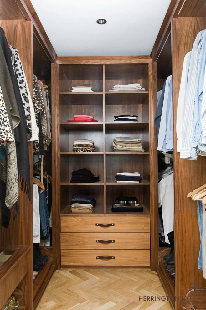 Example of a small trendy walk-in closet design in Other with open cabinets and medium tone wood cabinets