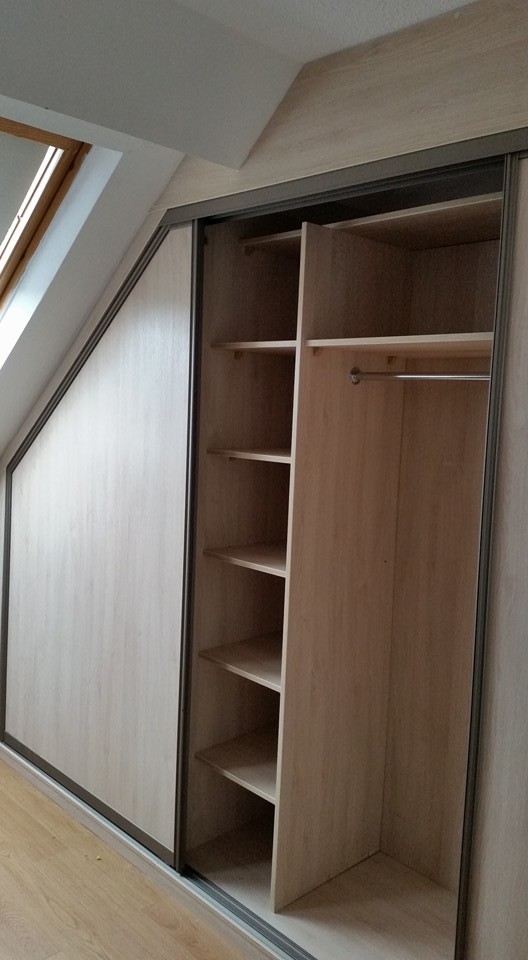 This is an example of a gender neutral standard wardrobe in Dublin with glass-front cabinets and black cabinets.