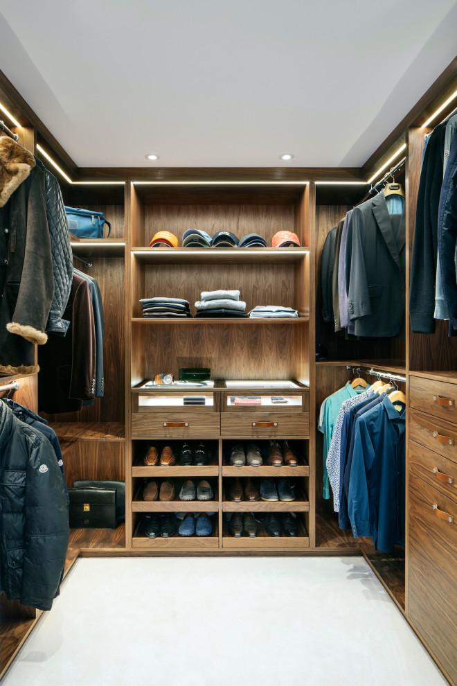 Inspiration for a medium sized contemporary walk-in wardrobe for men in Essex with flat-panel cabinets, medium wood cabinets, white floors and carpet.