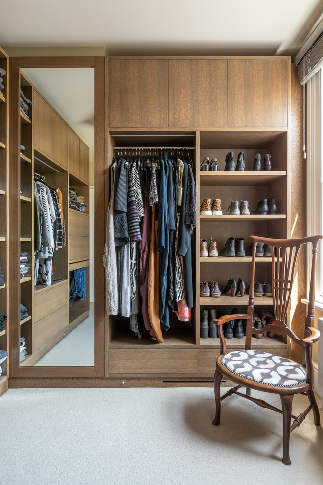 Inspiration for a bohemian gender neutral walk-in wardrobe in Cambridgeshire with open cabinets, medium wood cabinets, carpet and grey floors.