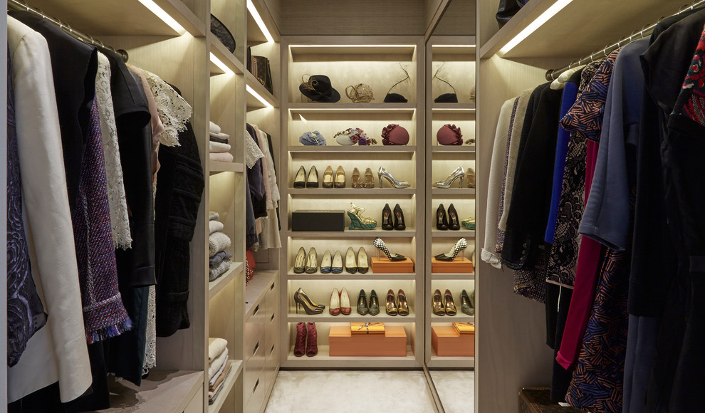 Inspiration for a contemporary women's walk-in closet remodel in London with open cabinets and light wood cabinets