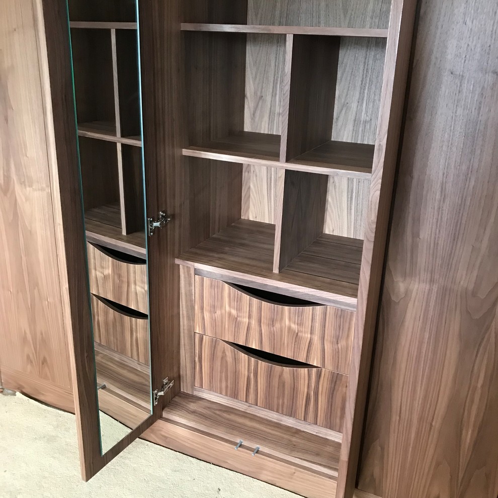 Design ideas for a medium sized classic standard wardrobe in Glasgow with flat-panel cabinets and dark wood cabinets.