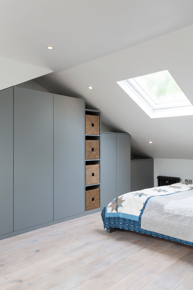 Photo of a scandinavian wardrobe in London with beige floors.