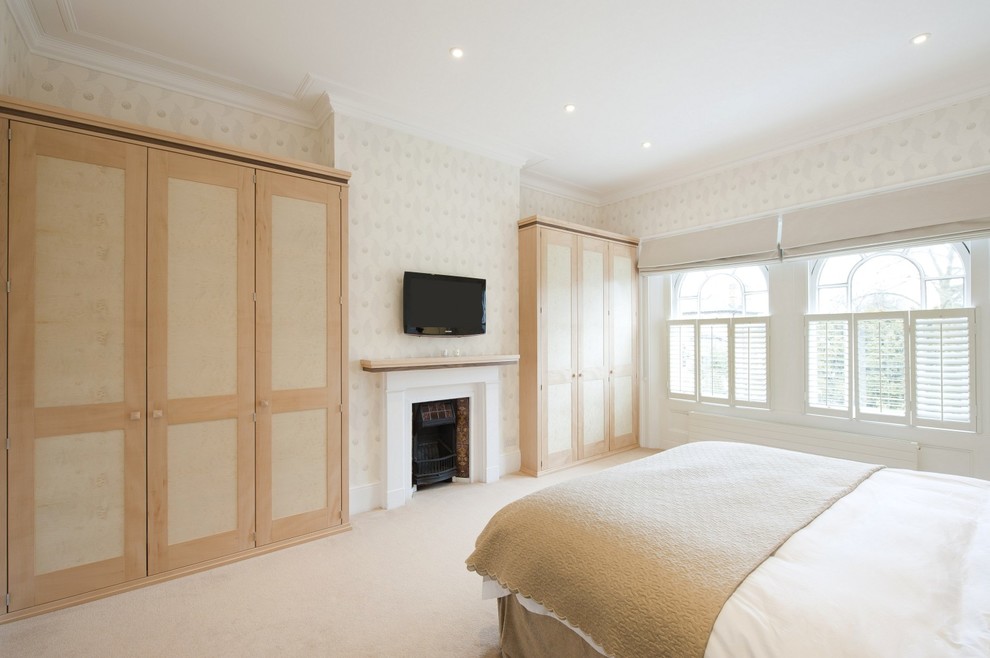 Photo of a medium sized classic bedroom in London with carpet and white floors.