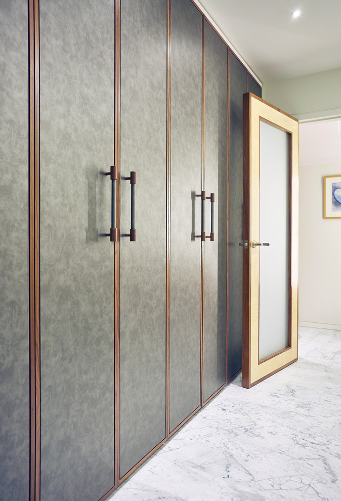 Design ideas for a modern wardrobe in Devon with flat-panel cabinets and grey cabinets.