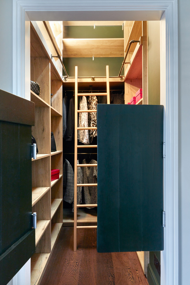 Photo of a small contemporary dressing room for men in London with open cabinets, medium wood cabinets, dark hardwood flooring and brown floors.