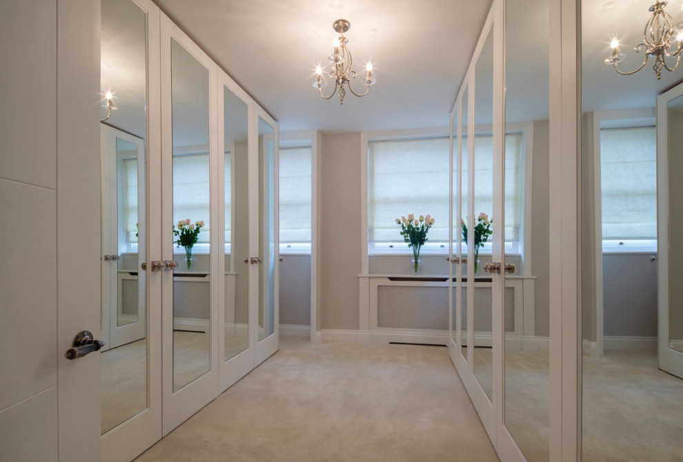 Gender-neutral carpeted, beige floor and coffered ceiling walk-in closet photo in London