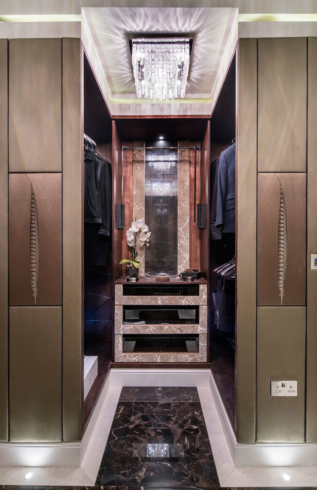 Medium sized contemporary gender neutral walk-in wardrobe in London with open cabinets, dark wood cabinets and marble flooring.