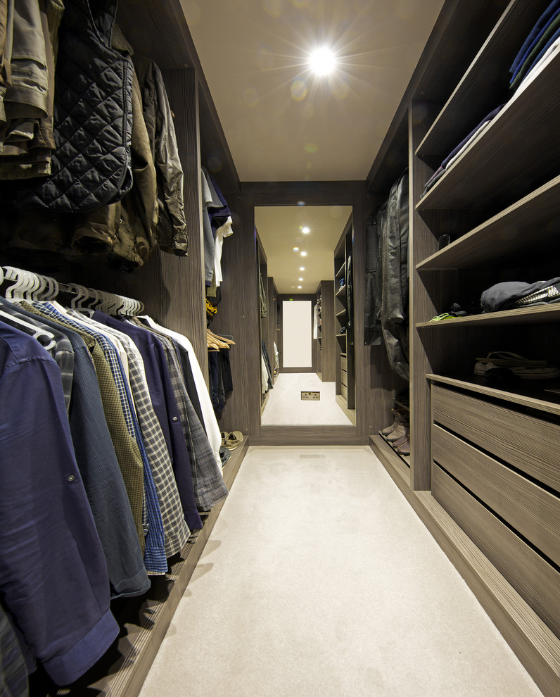 This is an example of a medium sized contemporary wardrobe in Hertfordshire with carpet and beige floors.