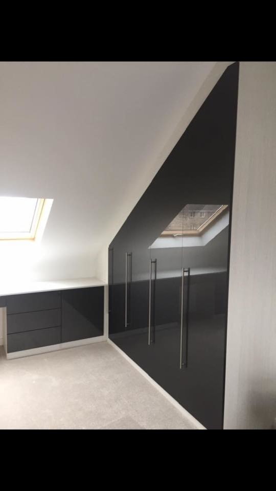Inspiration for a contemporary standard wardrobe in Dorset with glass-front cabinets and black cabinets.