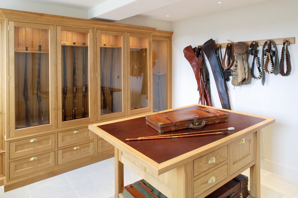Medium sized traditional wardrobe in London with raised-panel cabinets, medium wood cabinets and limestone flooring.