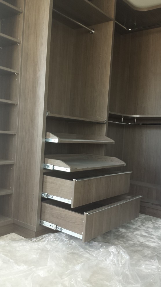 Design ideas for a medium sized gender neutral walk-in wardrobe in London with open cabinets and medium wood cabinets.