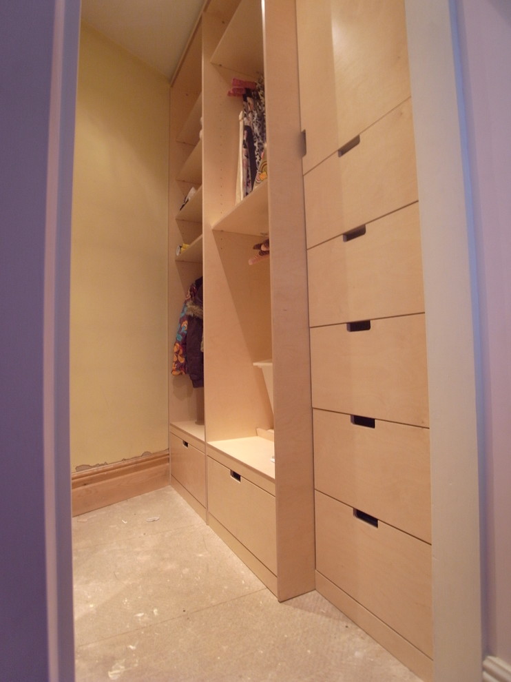 Walk-in closet - small modern walk-in closet idea in London with open cabinets and light wood cabinets