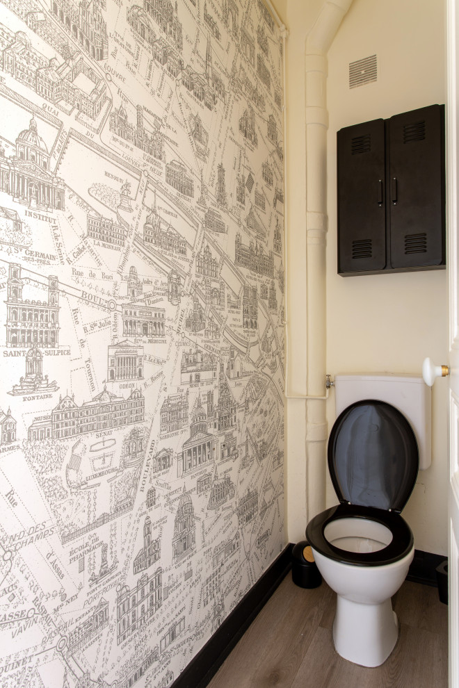 Cette image montre un WC et toilettes design avec WC à poser, un mur beige et du papier peint.