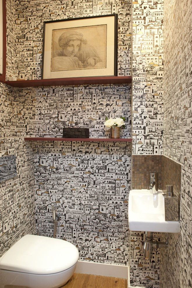 Inspiration för ett mellanstort funkis toalett, med en vägghängd toalettstol, flerfärgade väggar, mellanmörkt trägolv och ett fristående handfat