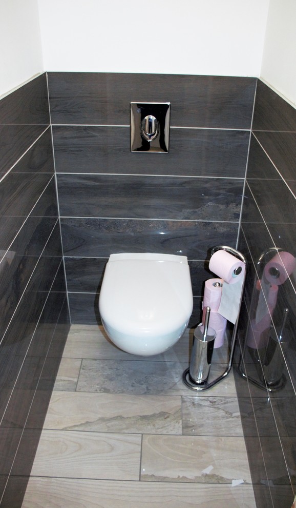 Inspiration for a medium sized contemporary cloakroom in Grenoble with a wall mounted toilet, white tiles, ceramic tiles and ceramic flooring.