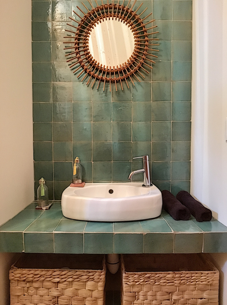 Стильный дизайн: туалет в современном стиле с инсталляцией, зеленой плиткой, терракотовой плиткой, белыми стенами, полом из керамической плитки, накладной раковиной, столешницей из плитки, бежевым полом и зеленой столешницей - последний тренд