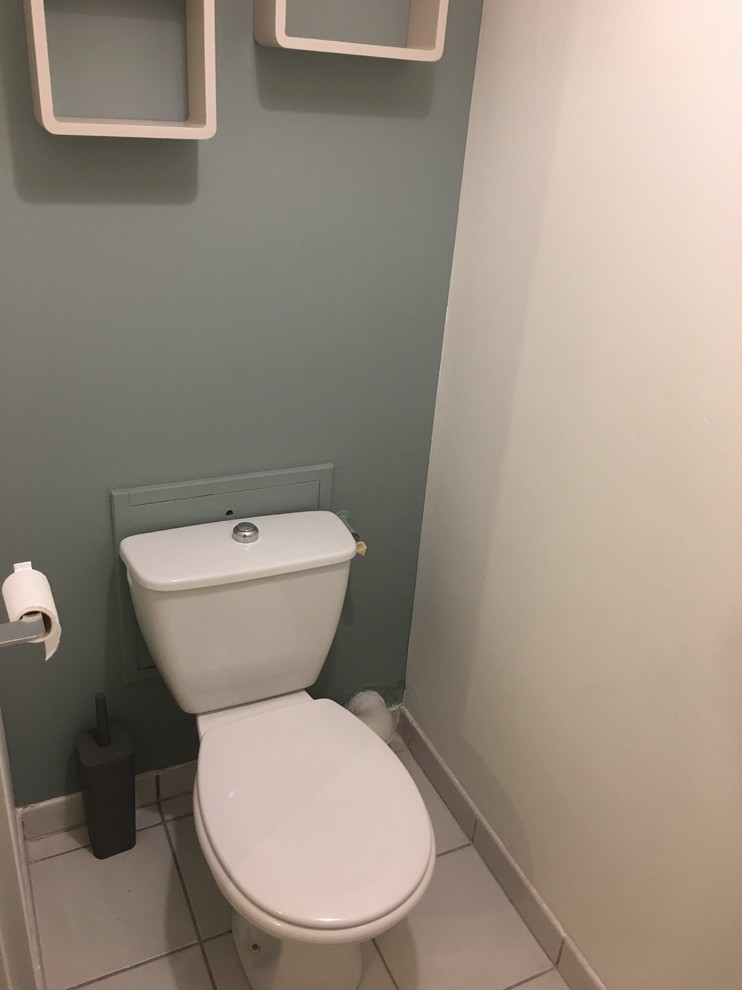 На фото: маленький туалет в скандинавском стиле с белым полом, синими стенами и полом из цементной плитки для на участке и в саду