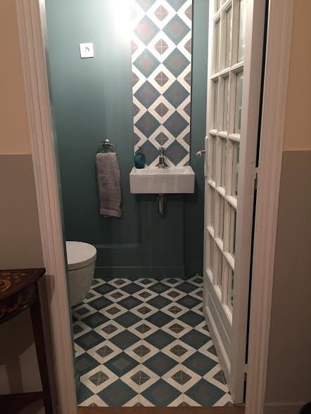 Photo of a cloakroom in Paris with cement tiles and cement flooring.