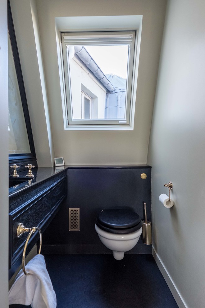 Mid-sized mid-century modern powder room photo in Paris with dark wood cabinets, a wall-mount toilet, white walls and an undermount sink
