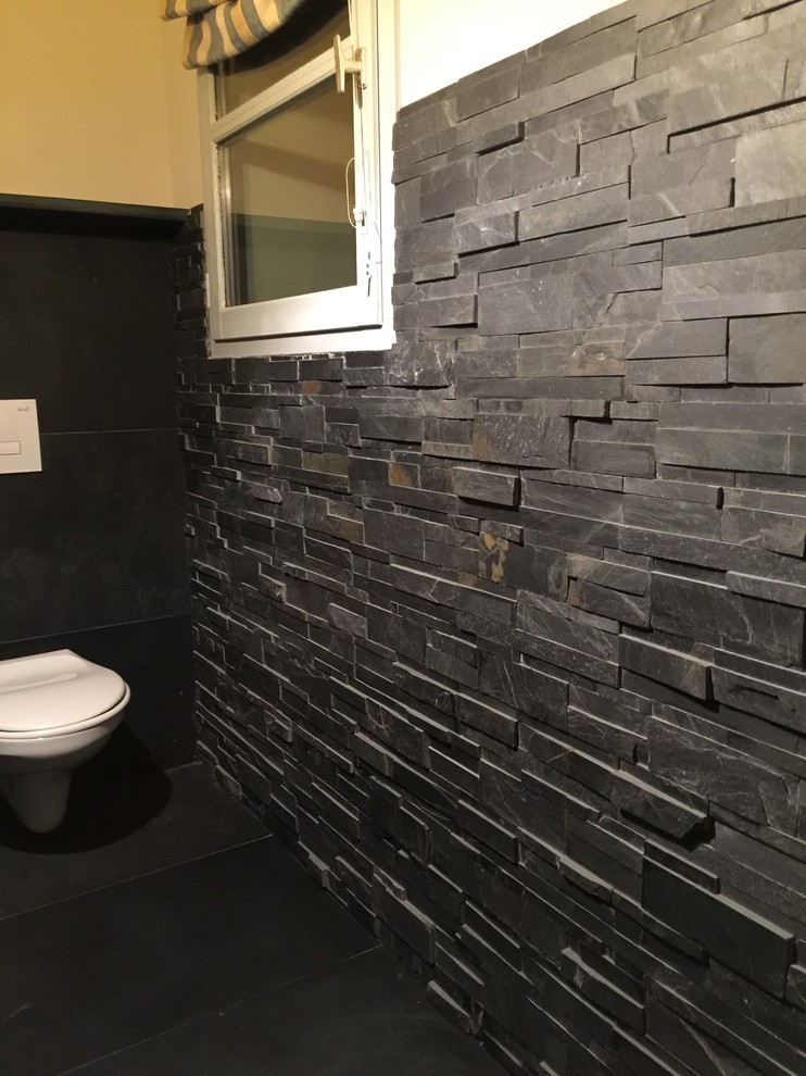 Medium sized contemporary cloakroom in Toulouse with a wall mounted toilet.