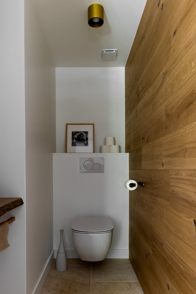 Ispirazione per un bagno di servizio contemporaneo di medie dimensioni con pareti bianche, pavimento in pietra calcarea, lavabo a bacinella e pavimento beige