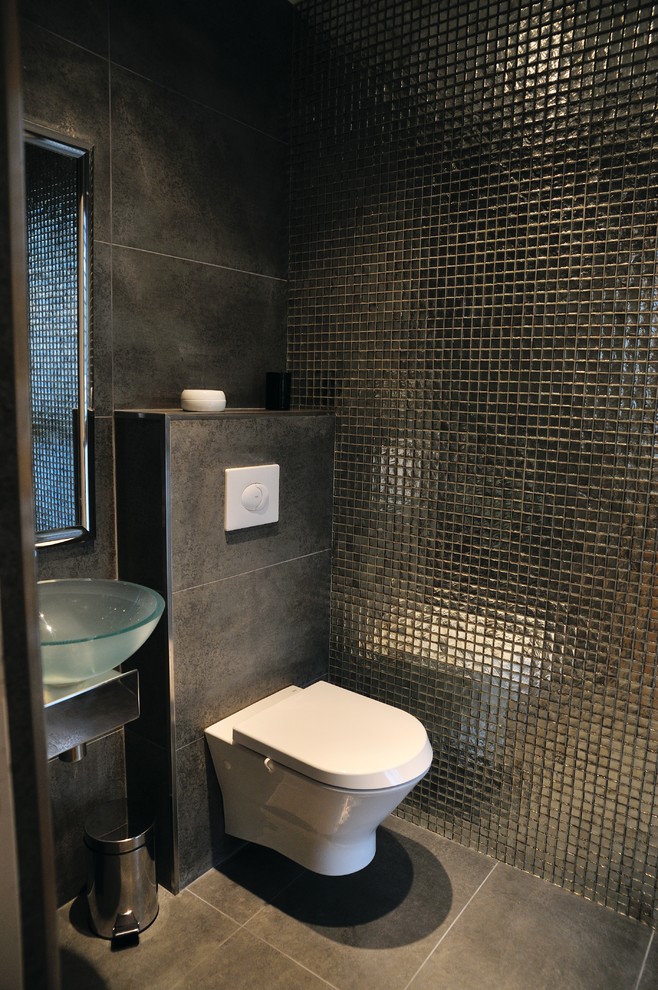 Inspiration for a medium sized contemporary cloakroom in Paris with a wall mounted toilet, brown tiles, mosaic tiles, brown walls, ceramic flooring, a built-in sink, brown floors and brown worktops.